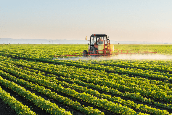Agricultural tractor in green field